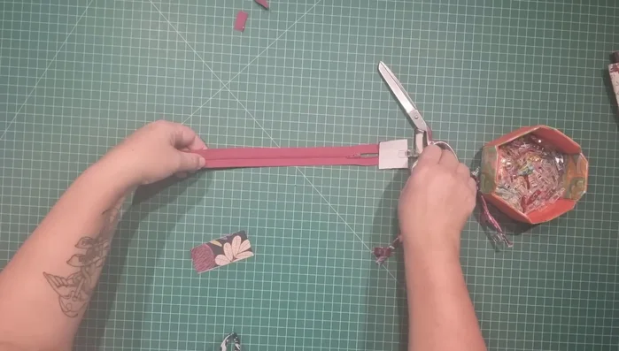 Attach zipper to outer fabric: Measure 11 inches from the edge of zipper. Use double-sided tape or pins to secure the zipper to the top edge of the outer fabric, aligning centers. Repeat with lining (right sides together). Stitch across the top.