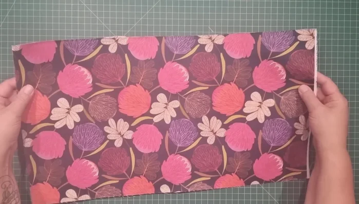 Prepare fabric and batting: Cut outer fabric (12" x 22"), lining (12" x 22.5"), handle (2.5" x 12"), zipper tabs (1.5" x 3"), and fuse lightweight batting to outer fabric.