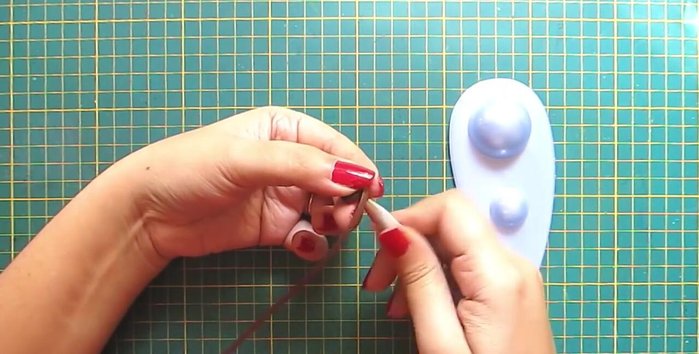 Make the reindeer's face: Create a semicircle with a dark brown strip for the muzzle. Add a golden strip for detail.