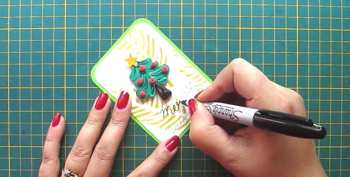 Add finishing touches: Write 'Merry Christmas' and attach a ribbon.