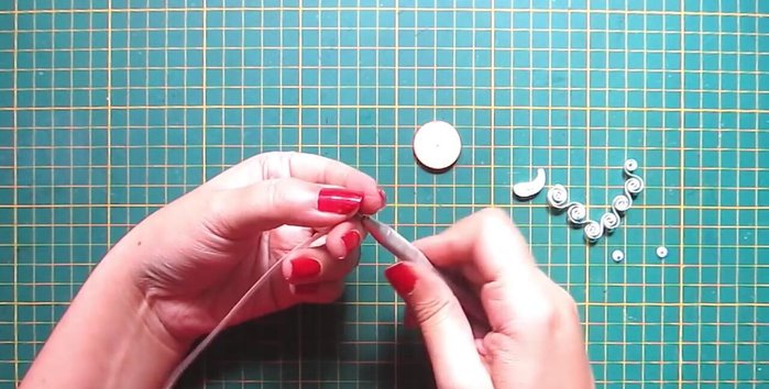 Create Santa's mustache: Make bended teardrop shapes with white strips.