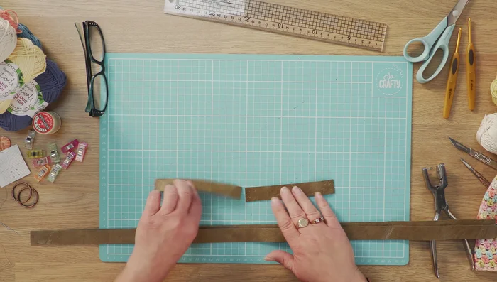 Prepare the leather straps and inner pieces. Cut your leather to your desired length and width. Mark out stitch holes before punching to avoid tearing.