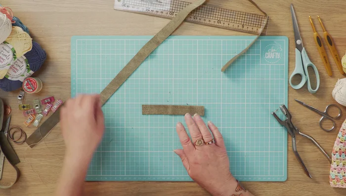 Position the inner piece (swayed side up) and strap (swayed side down), overlapping them. Decide how high you want the straps on your bag.