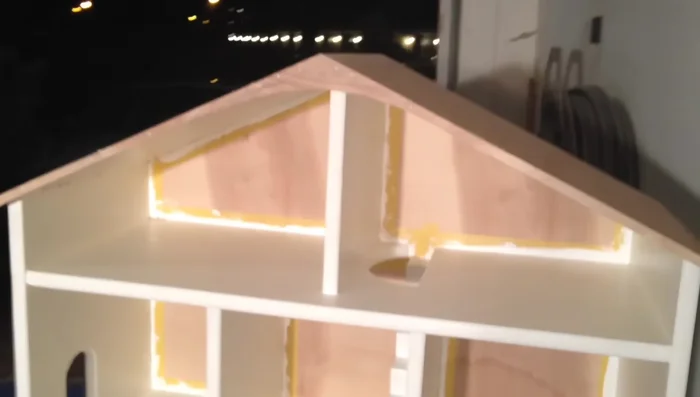 Roof Construction: Popsicle sticks were used to create miniature shingles, glued and clamped onto the roof. This was a time-consuming step.