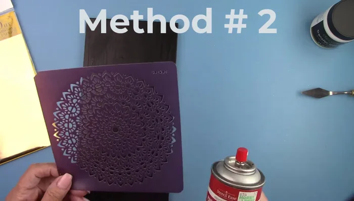 Spray the stencil with repositionable adhesive.