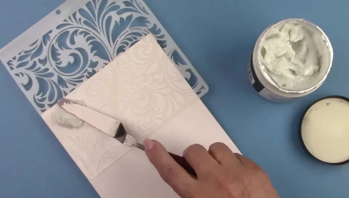 Spray stencil with adhesive.