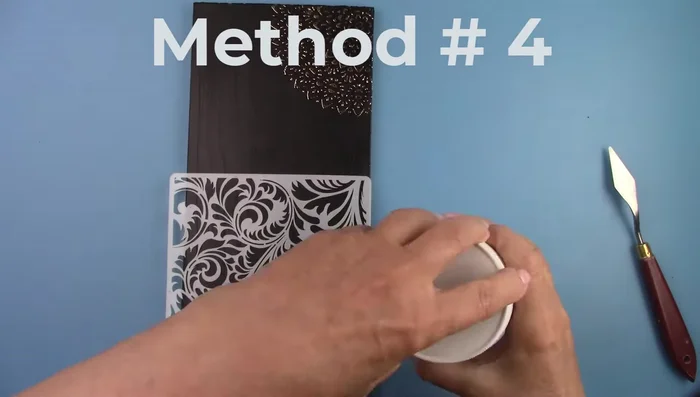 Add paint to some of the crackle paste and spread it over the stencil.