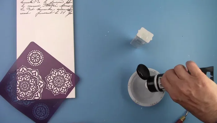 Mix glass gel medium with glitter, spread over the stencil and let it dry overnight.