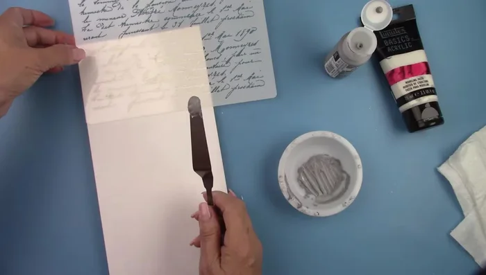 Spread the paste over the stencil using a palette knife.