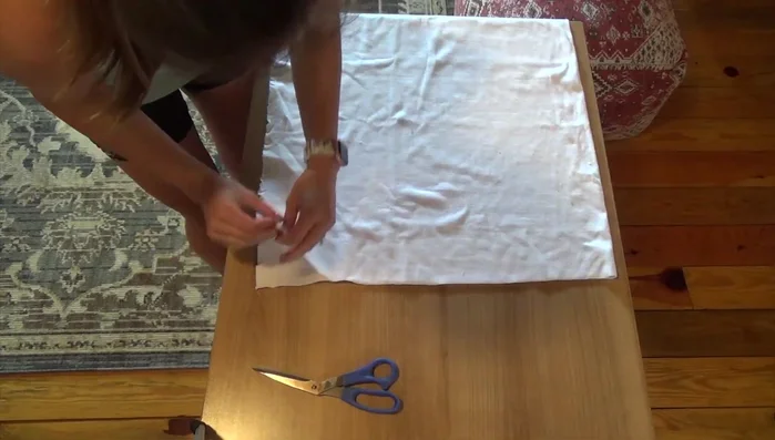 Create collar shape: Fold the sewn ribbing strip in half lengthwise (slightly over an inch wide), aligning the seam. Pin, then fold in half again, pinning at the quarter marks to create a circle.