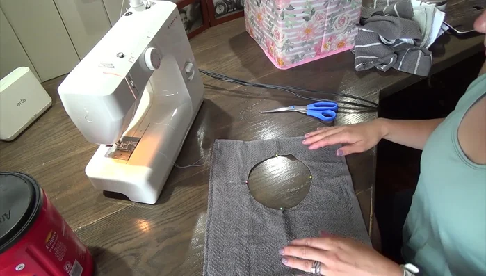 Sew collar to bib: Sew the collar to the bib using a zig-zag stitch, stretching the ribbing evenly as you sew. Start at the back seam and continue around, readjusting the fabric every few inches to maintain an even tension.