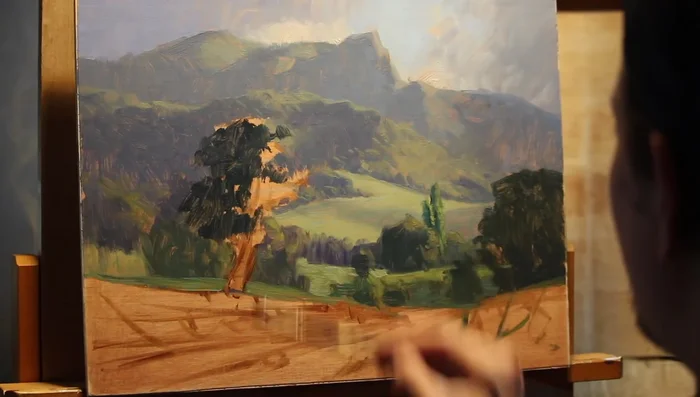 Paint the riverbank, using fragmented brushstrokes to create clumps and tussocks of grass. Suggest water reflections by mirroring colors from above the waterline.