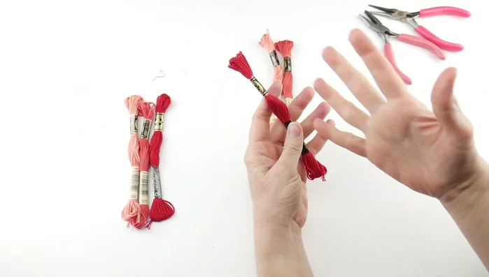 Prepare the embroidery floss: Pull out about 12 inches of floss, remove the paper sleeves, and cut the floss in half.