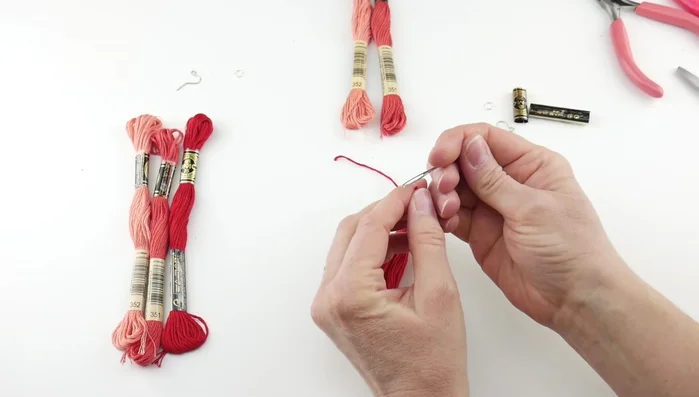 Neaten the tassel: Use a tapestry needle to thread under the top knot to make the tassel less unruly and pointing downwards. Trim any excess loops.