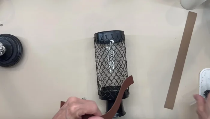 Drape the netting over the vase and secure the edges with faux suede strips.