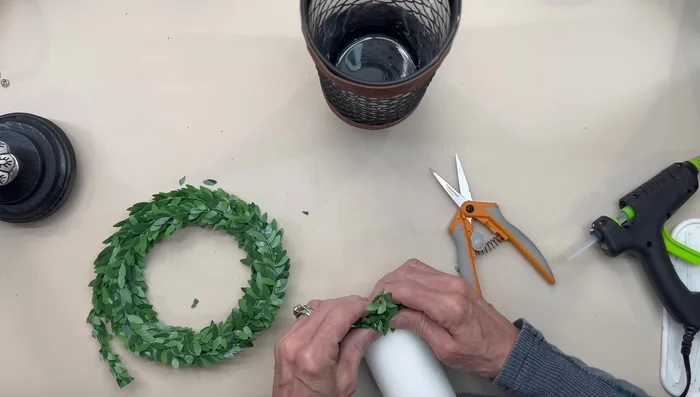 Add a candle and boxwood garland.