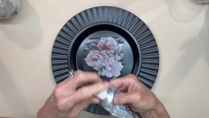 Attach the pie plate to the Dollar Tree charger.