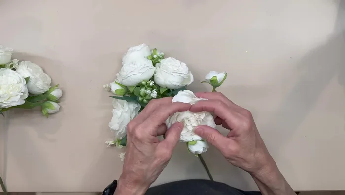 Arrange peonies for display.