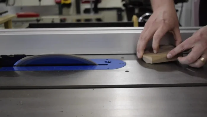 Cut a chamfer into the mitered edge of the coasters.