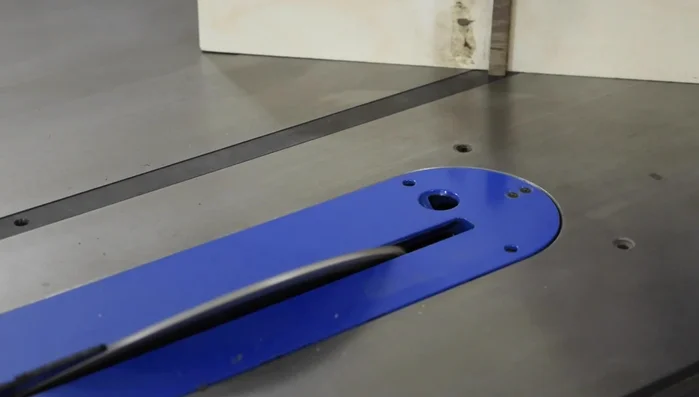 Cut a chamfer into the mitered edge of the coasters.