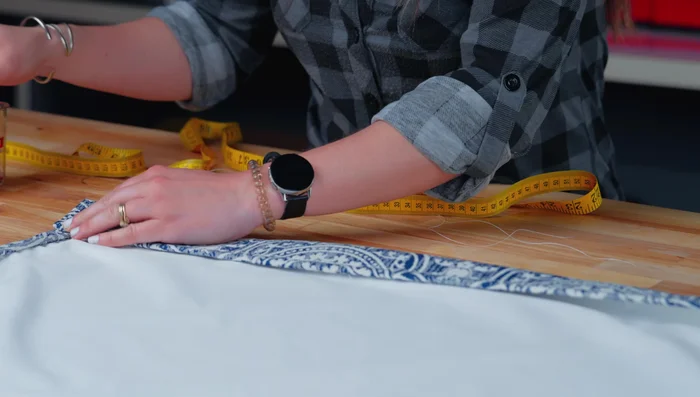 Fold the bottom inward 2 1/2 inches, ensuring the liner is also folded in. Hand sew the top using a whip stitch or machine sew with a 1/2-inch seam allowance.