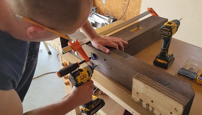 Attach the legs to the base using five-inch screws and glue.