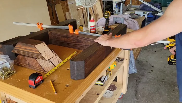 Attach the tabletop using five-inch screws, glue, and clamps.