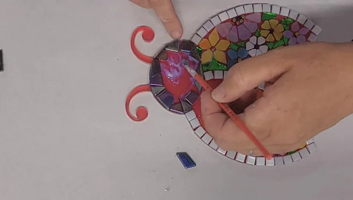 Fill in the ladybug's head with smaller pieces.