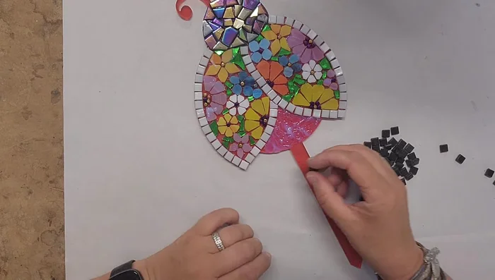 Create the bottom of the ladybug using 8mm gloss tiles, cutting angles to ensure a snug fit.