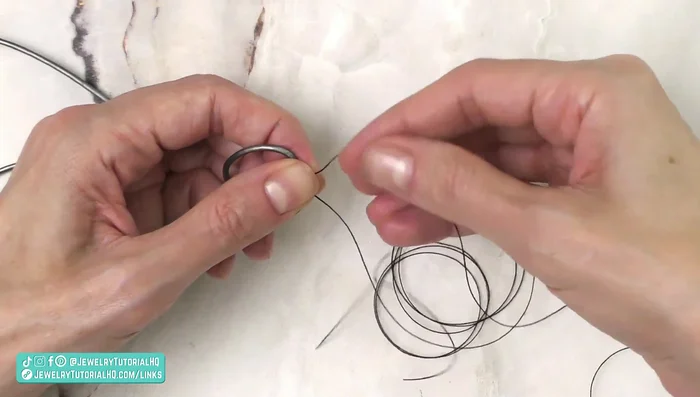 Tie a knot in the thread (and a second knot for security). Untie the initial test knot in the leather ends.