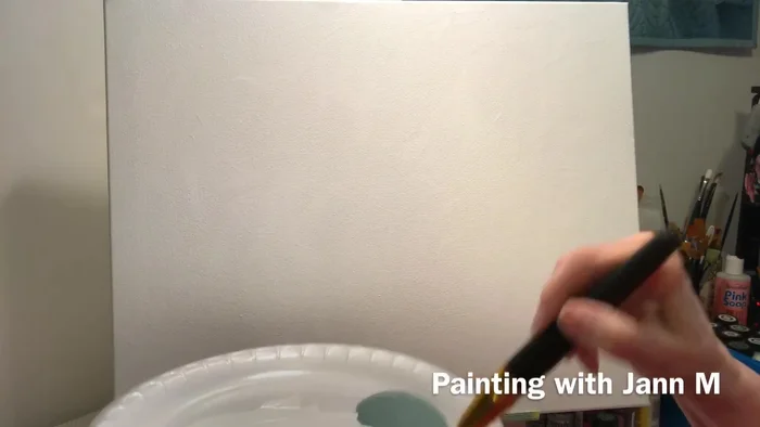 While the white paint is still wet, blend in Folk Art Greenscape (or your desired color) using a crisscross stroke. Do not cover the entire canvas; focus on specific areas.