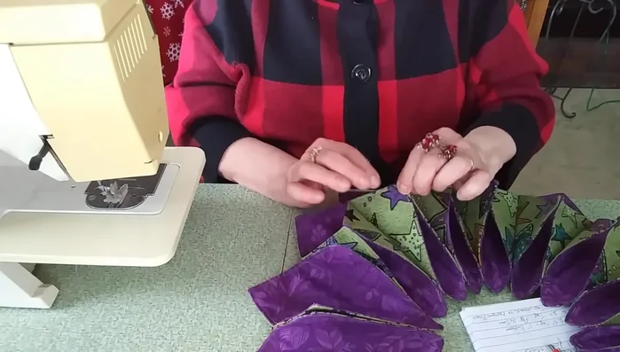 Add finishing touches: Create small tucks at each petal point. Stitch these tucks together to secure them. Add buttons, beads, or other embellishments as desired.