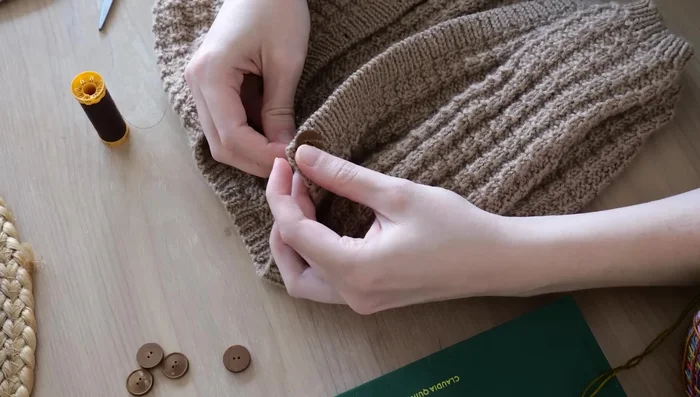 Sew on buttons using sewing thread.