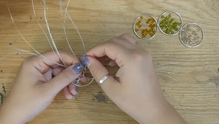 Thread beads onto the branches. Split branches to add beads along their length.
