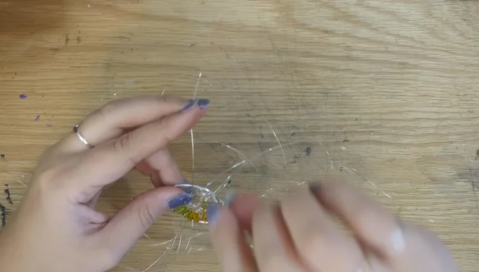 Once beads are added, wrap excess wire around the ring, securing it to the roots. Continue wrapping excess wire around branches and securing.