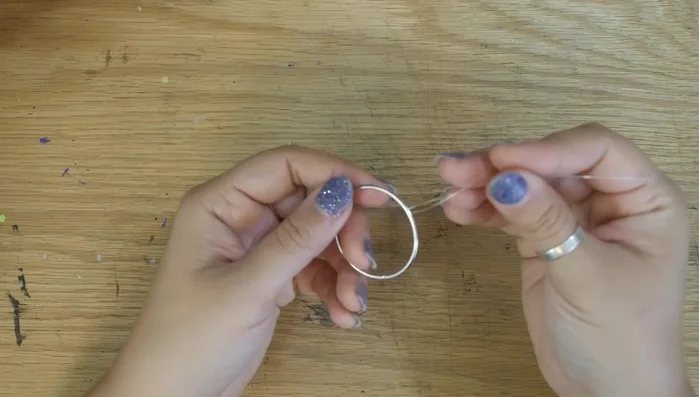 Thread one wire through the ring and wrap it around three times to secure. Repeat with all wires.