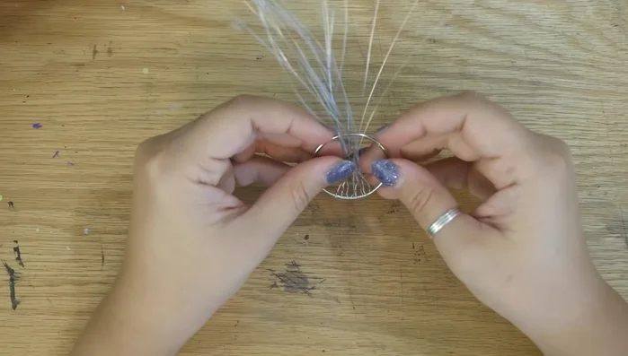 Flip the wires up, inside the ring, and twist them together to form the trunk. You can bend the trunk for a more interesting look.