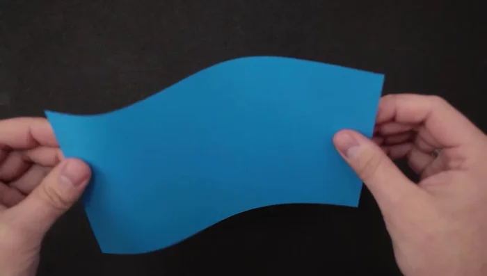 Divide the top edge of the paper into thirds by bending it like an 'S' and pinching to make marks.