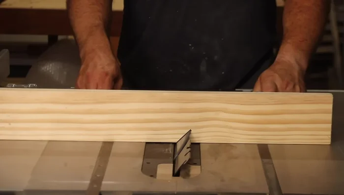 Cut 45-degree angles on the sides using a table saw and auxiliary fence.