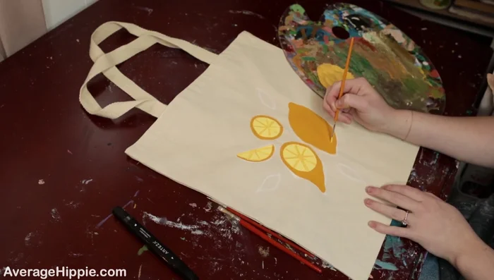 Add highlights. Use a lighter color to add highlights to your design, creating a 3D effect. The example adds highlights to the lemons and leaves.