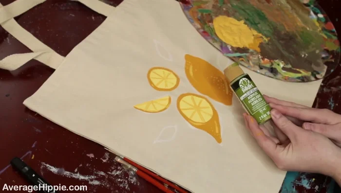 Paint the leaves. Using a base green and a lighter green, paint in the leaves, adding highlights for depth.