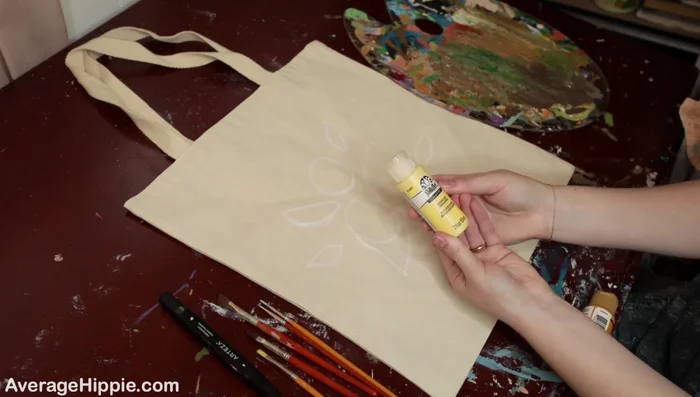 Paint the base colors. Begin painting the larger areas of your design. Start with darker shades and gradually add lighter colors. The example uses darker and lighter yellows for the lemons.