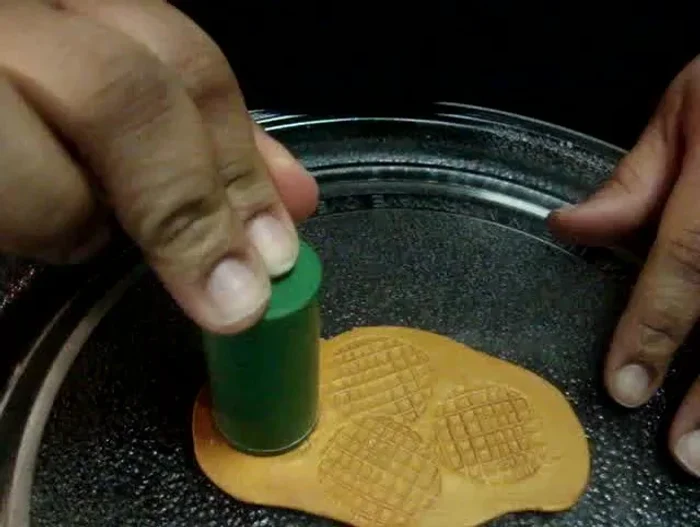 Roll the clay circles into a cone shape, being gentle to preserve the pattern.