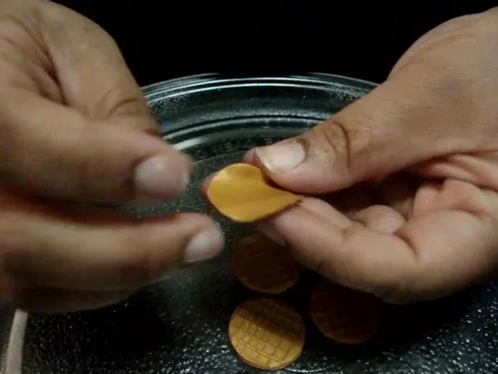 Roll the clay circles into a cone shape, being gentle to preserve the pattern.