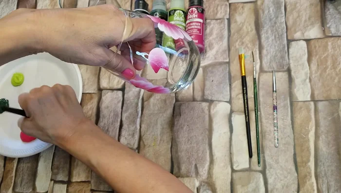 Add rose buds using an upside-down U shape with white paint on top, followed by magenta.