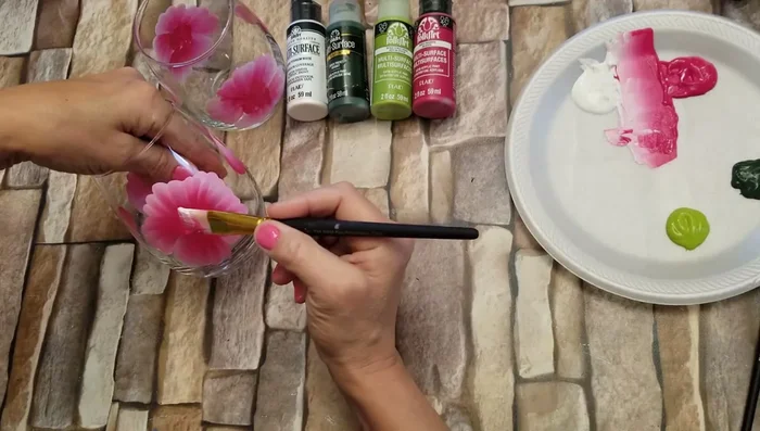 Paint the inside cup of the large roses using an upside-down U shape, holding the brush perpendicular to the glass.