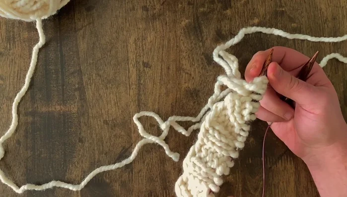 Determine if you are creating a left or right pocket based on the placement of the picked-up and cast-on stitches (purl the picked-up and cast-on stitches on the first row for a left pocket).