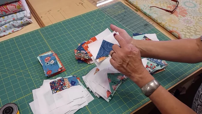 Stitch the main block components together, paying attention to seam alignment and pressing directions to maintain sharp points.