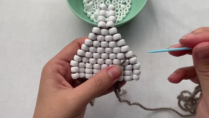 Weave the tail back through the foundation beads to hide it.