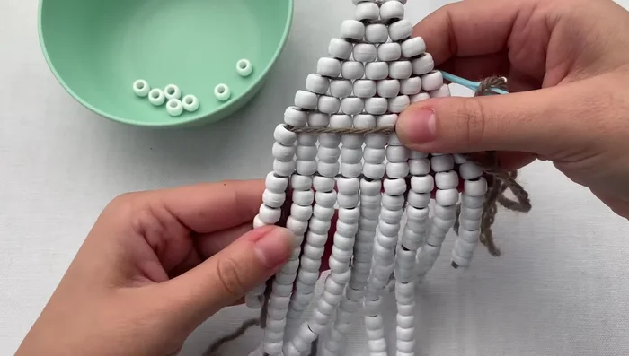 Weave the remaining thread through the foundation to hide and secure it. Trim excess thread.